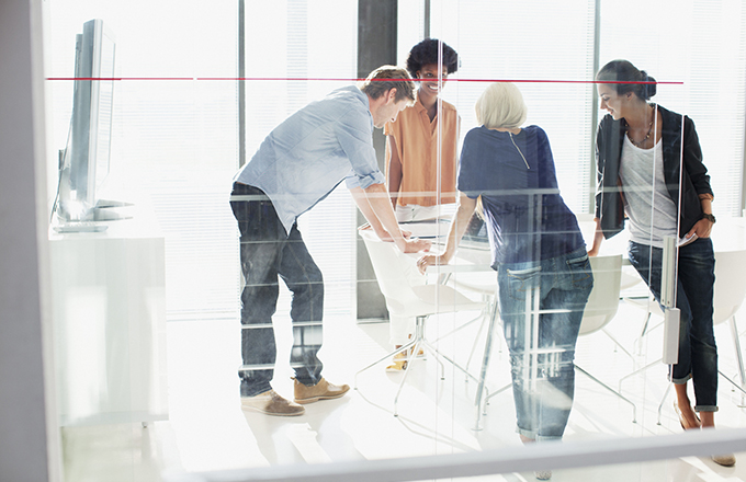 Business people meeting in sunny conference room